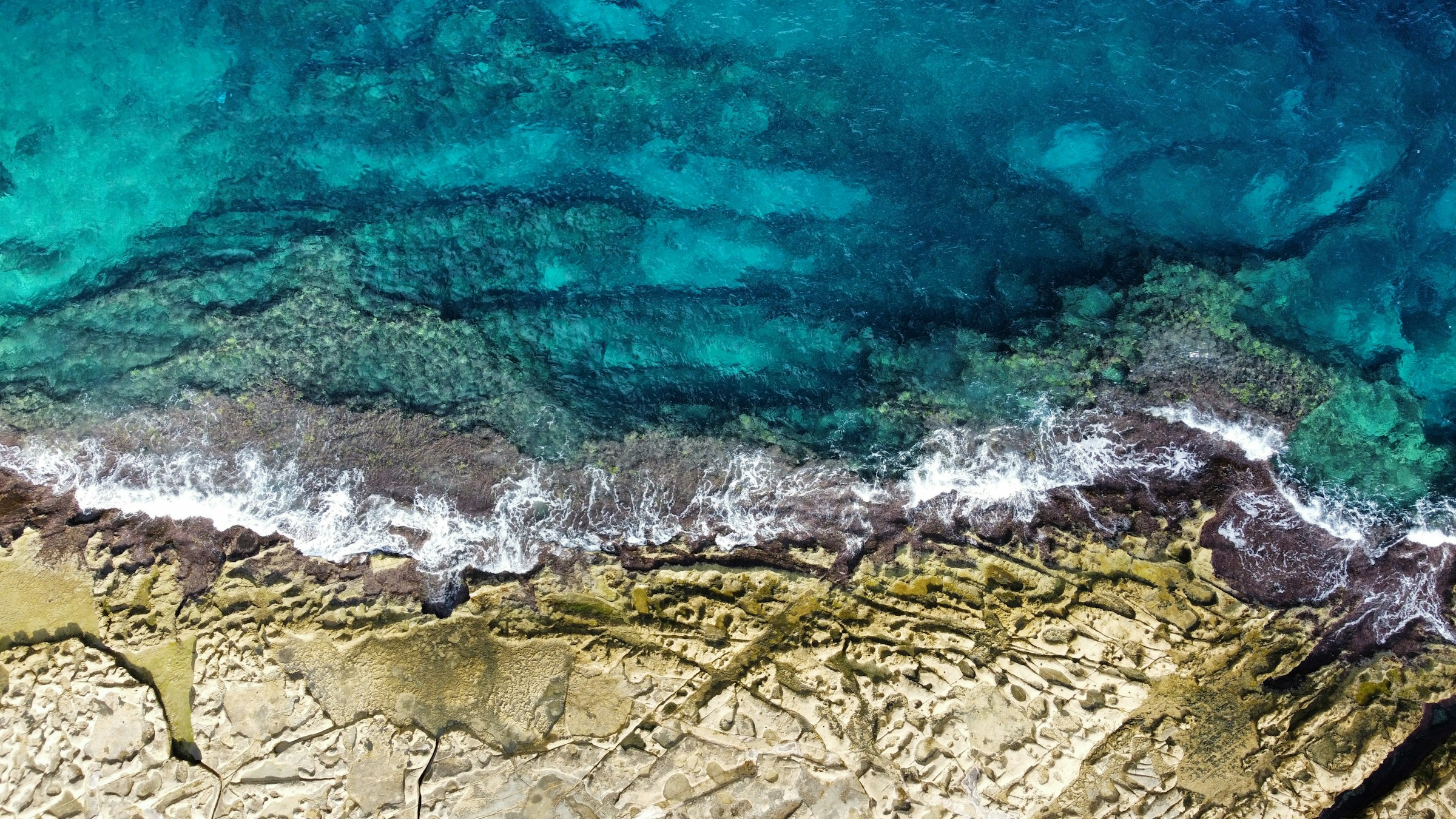 An aerial view of Malta’s limestone coastline and Mediterranean waters
